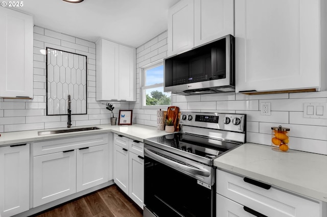 5414 SE 97th Ave, Portland, OR 97266 - kitchen featuring stainless steel electric range, backsplash, white cabinets, light stone countertops, and dark wood-type flooring