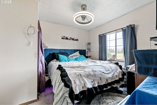 bedroom featuring carpet flooring and a textured ceiling