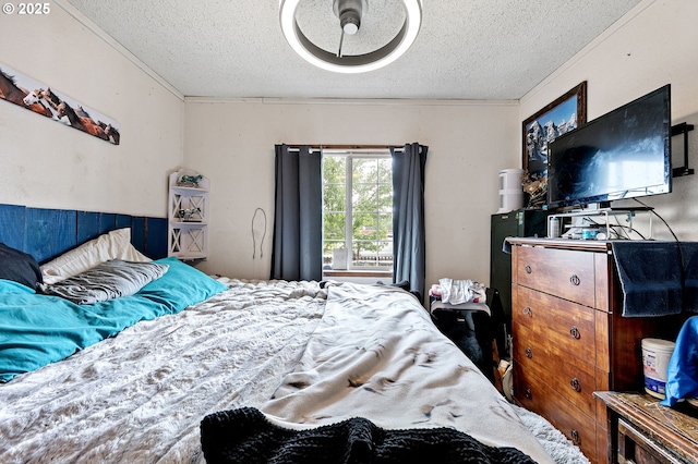 bedroom with a textured ceiling and ornamental molding