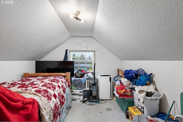 bedroom with a textured ceiling, carpet floors, and lofted ceiling