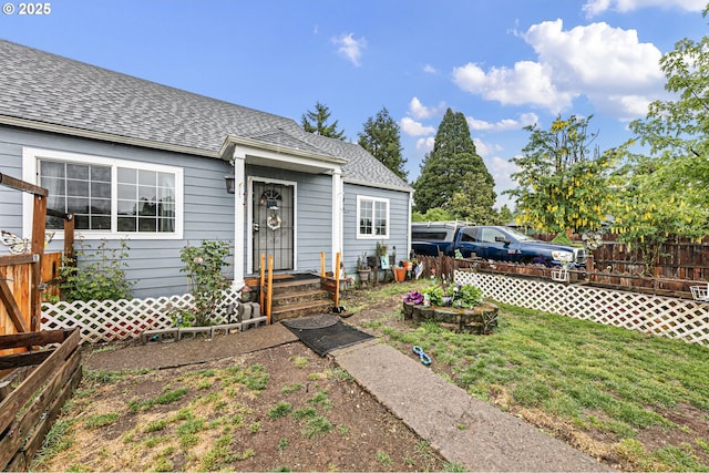 property entrance featuring roof with shingles