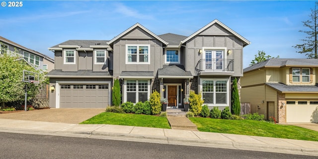 view of front of home with a garage, board and batten siding, a front yard, concrete driveway, and a balcony