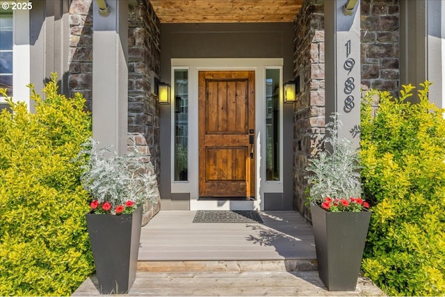 doorway to property featuring stone siding