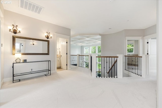 hallway featuring visible vents, baseboards, an upstairs landing, carpet, and coffered ceiling