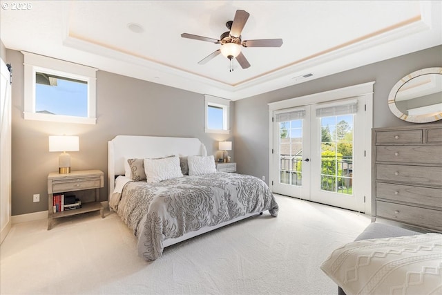 bedroom featuring french doors, visible vents, carpet floors, access to outside, and a tray ceiling