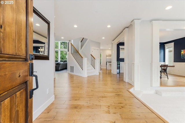 foyer entrance with visible vents, recessed lighting, stairs, and light wood-style floors