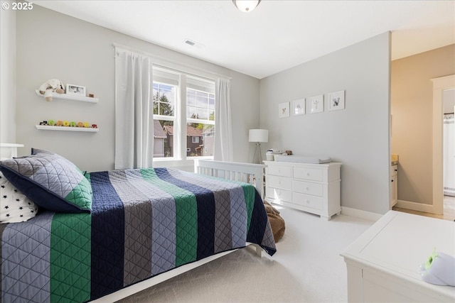 carpeted bedroom featuring visible vents and baseboards