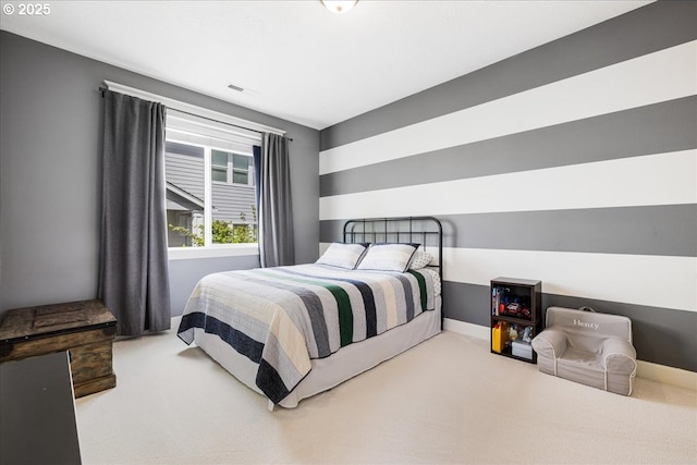 carpeted bedroom with baseboards and visible vents