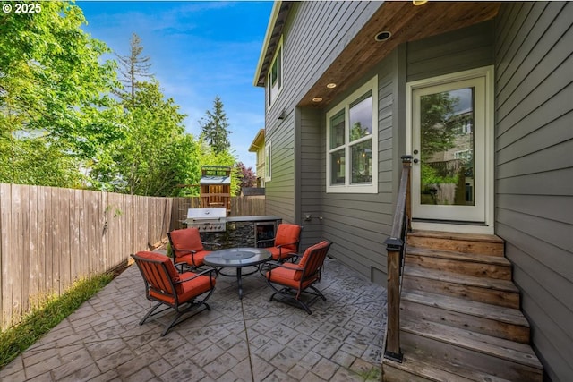 view of patio featuring a fenced backyard, entry steps, and a grill