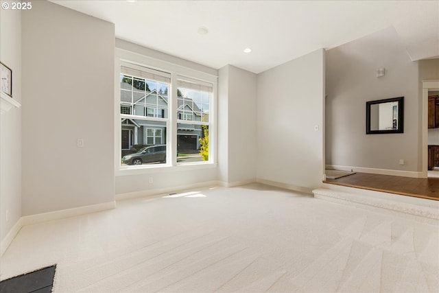 carpeted spare room with recessed lighting and baseboards