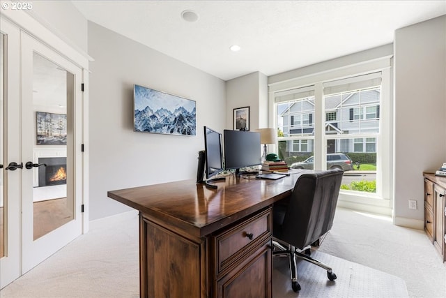 office space with baseboards, french doors, and light colored carpet