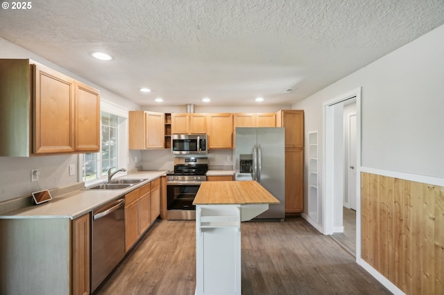 4702 NE 49th Ave, Vancouver, WA 98661 - kitchen featuring appliances with stainless steel finishes, a sink, wood finished floors, open shelves, and a textured ceiling