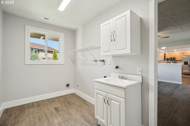 4702 NE 49th Ave, Vancouver, WA 98661 - laundry room featuring washer hookup, cabinet space, wood finished floors, electric dryer hookup, and baseboards