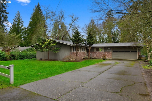 view of front of home with brick siding, an attached garage, driveway, and a front lawn