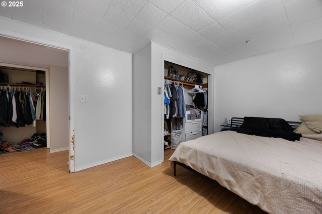 bedroom featuring light wood-style floors, a closet, and baseboards