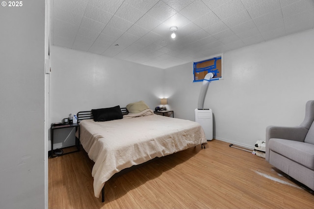 bedroom with baseboards and light wood-style floors