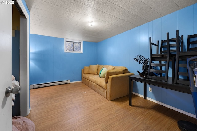 living room featuring wood finished floors, baseboards, and baseboard heating