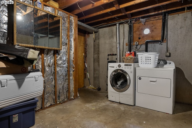 unfinished below grade area with washer and clothes dryer