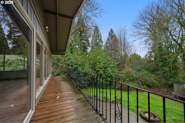 wooden terrace featuring a yard