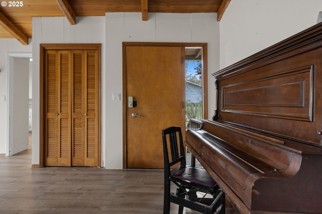 sitting room with beam ceiling, wooden ceiling, and wood finished floors