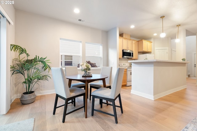 dining space with light wood-type flooring