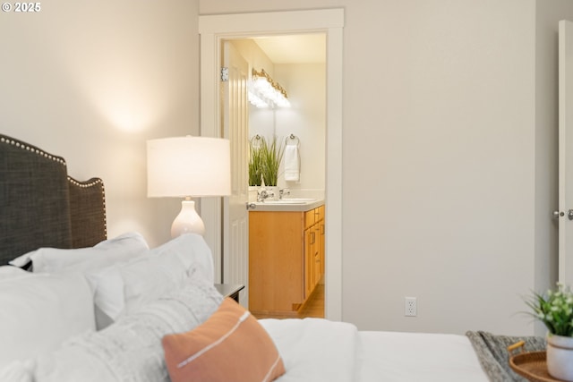 bedroom with ensuite bathroom and sink