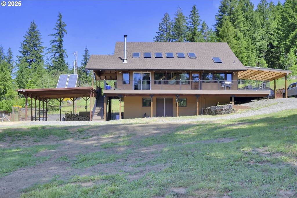 94464 Marcola Rd, Marcola, OR 97454 - back of house with stairs, a deck, a carport, and a shingled roof