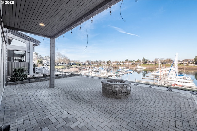 view of patio featuring a fire pit and a water view