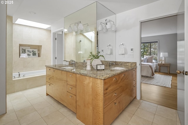 bathroom featuring a bath, tile patterned flooring, connected bathroom, and vanity