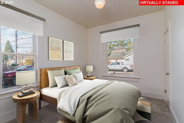 bedroom with carpet floors and a textured ceiling