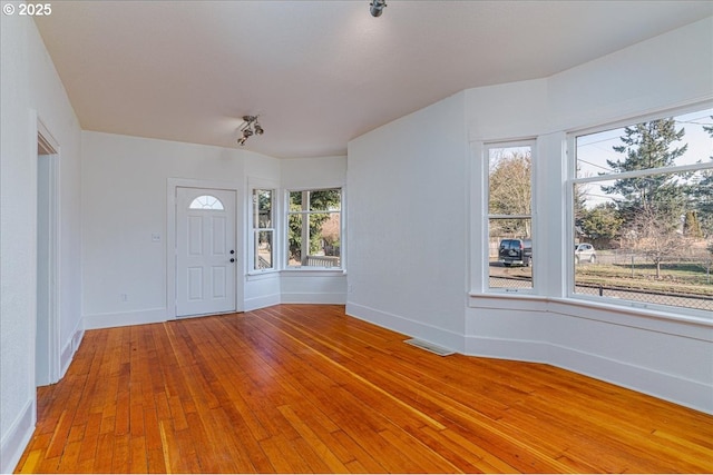 foyer entrance with light wood-type flooring