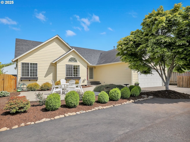 1689 Huckleberry Dr, Seaside, OR 97138 - view of front of home with roof with shingles, an attached garage, and a patio area
