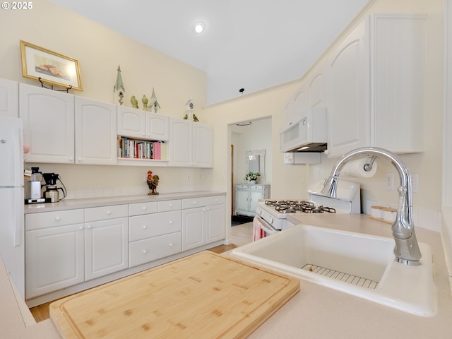 1689 Huckleberry Dr, Seaside, OR 97138 - kitchen featuring white appliances, white cabinets, a sink, light countertops, and recessed lighting