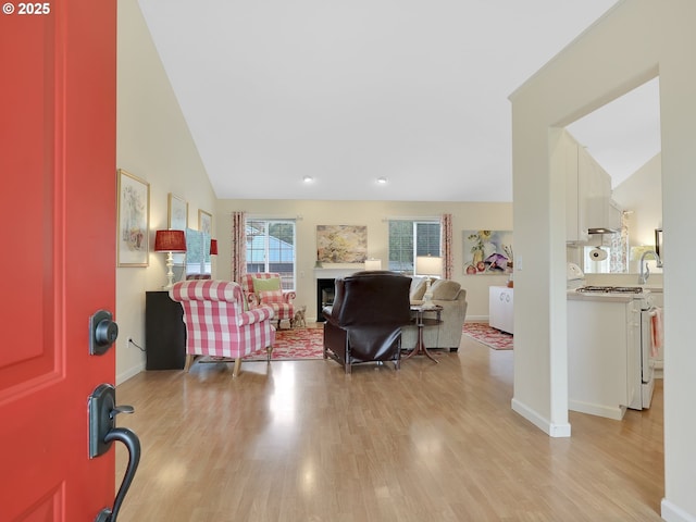 1689 Huckleberry Dr, Seaside, OR 97138 - living room with lofted ceiling, light wood-style flooring, and baseboards
