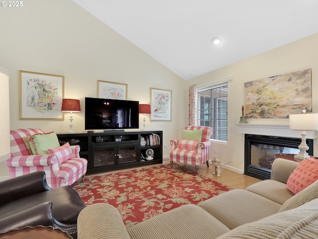 1689 Huckleberry Dr, Seaside, OR 97138 - living area with a glass covered fireplace, wood finished floors, lofted ceiling, baseboards, and recessed lighting