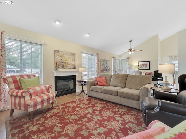 1689 Huckleberry Dr, Seaside, OR 97138 - living area featuring wood finished floors, a glass covered fireplace, ceiling fan, lofted ceiling, and recessed lighting