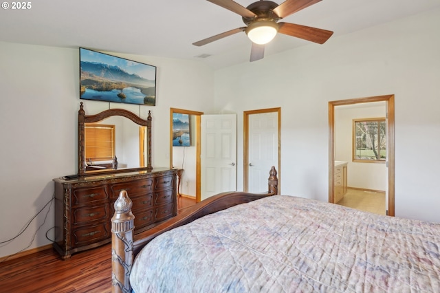 bedroom featuring dark wood-type flooring, ensuite bath, and ceiling fan