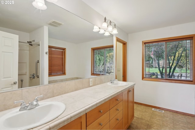 bathroom featuring walk in shower and vanity