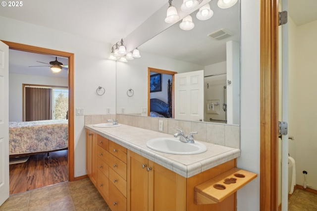 bathroom featuring ceiling fan and vanity