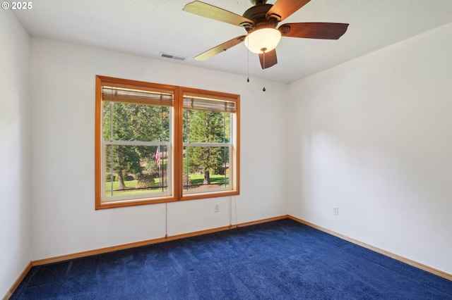 spare room featuring ceiling fan and carpet flooring