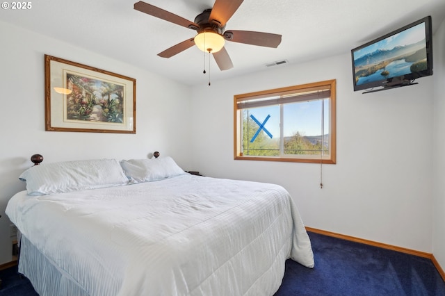 bedroom featuring ceiling fan and dark colored carpet