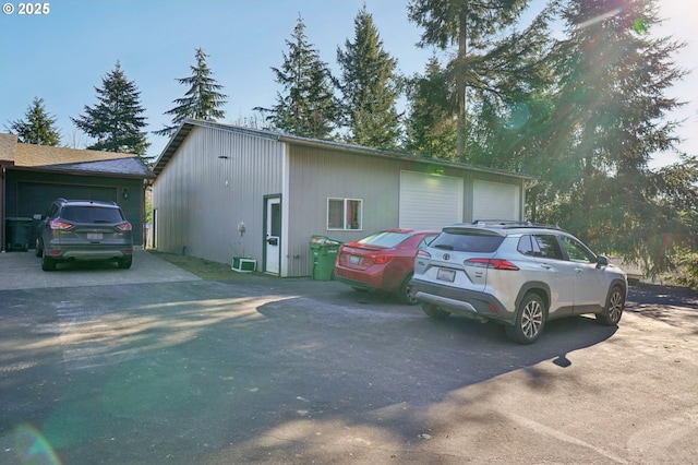 view of property exterior featuring an outbuilding and a garage