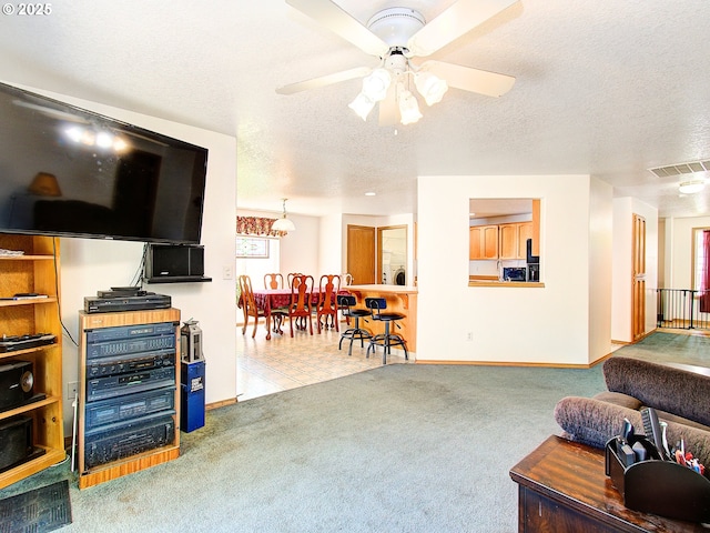 1313 NE 17th Ave, Battle Ground, WA 98604 - living area with a textured ceiling, carpet floors, a ceiling fan, and healthy amount of natural light