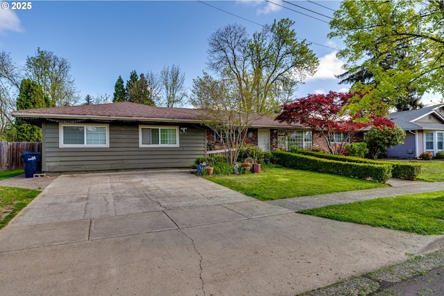 ranch-style house featuring concrete driveway