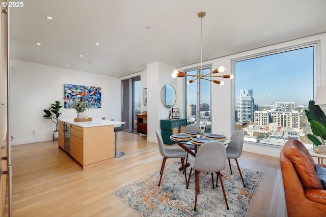 dining room featuring a notable chandelier and light hardwood / wood-style flooring