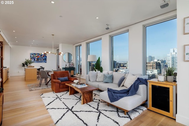 living room with a chandelier and light hardwood / wood-style floors