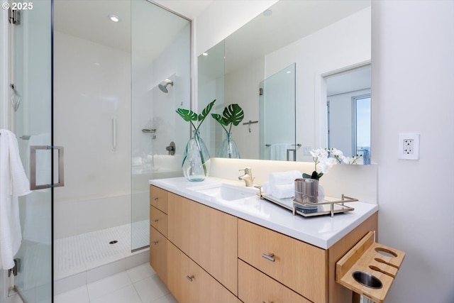 bathroom with tile patterned floors, vanity, and a shower with door