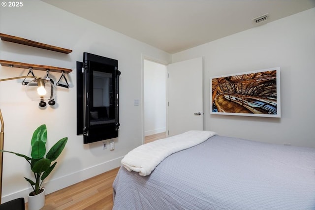 bedroom with light wood-type flooring