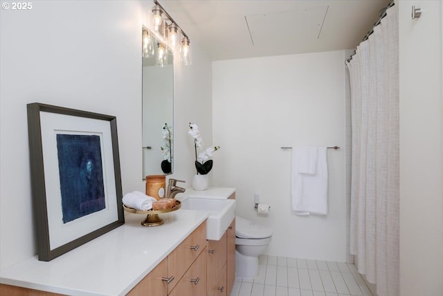 bathroom featuring tile patterned flooring, vanity, and toilet