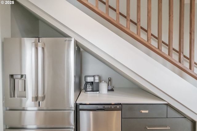 kitchen with gray cabinets, stainless steel appliances, and light countertops